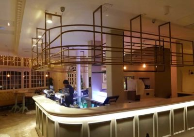 Bespoke counter bar with curved hanging bottle storage
